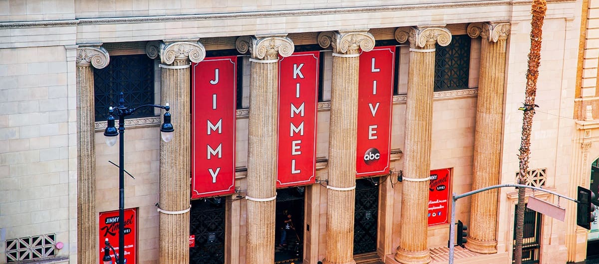 Three red banners that hang in front of the Hollywood Masonic Temple that read "Jimmy Kimmel Live"