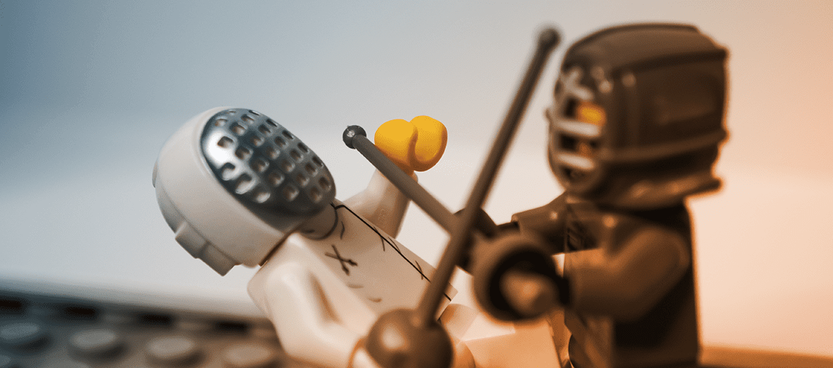 Two Lego figures in fencing gear fighting with swords