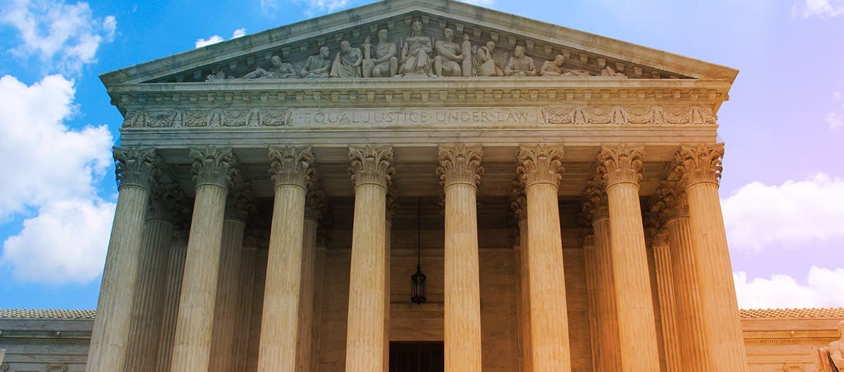 Supreme Court building front view with blue & purple skies