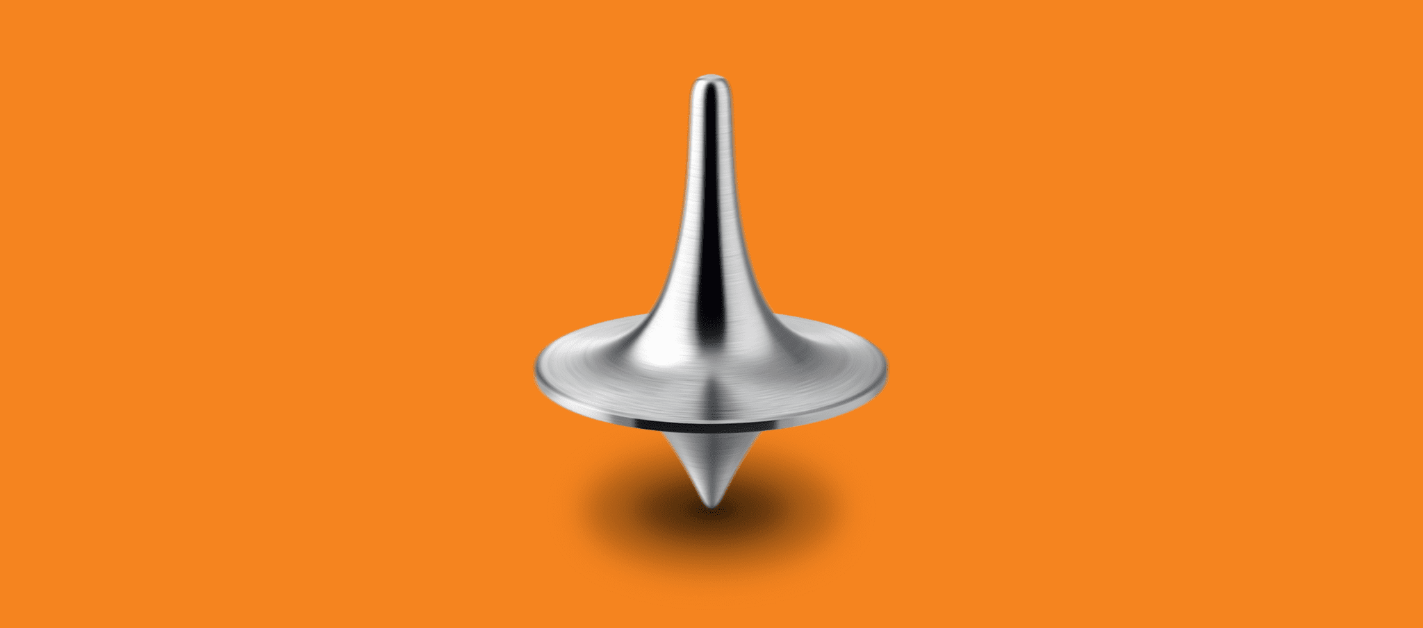A stainless steel spinning top on an orange background