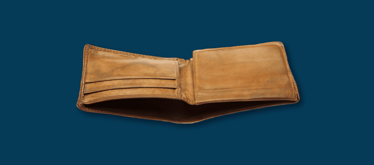 An empty, open wallet on a navy blue background