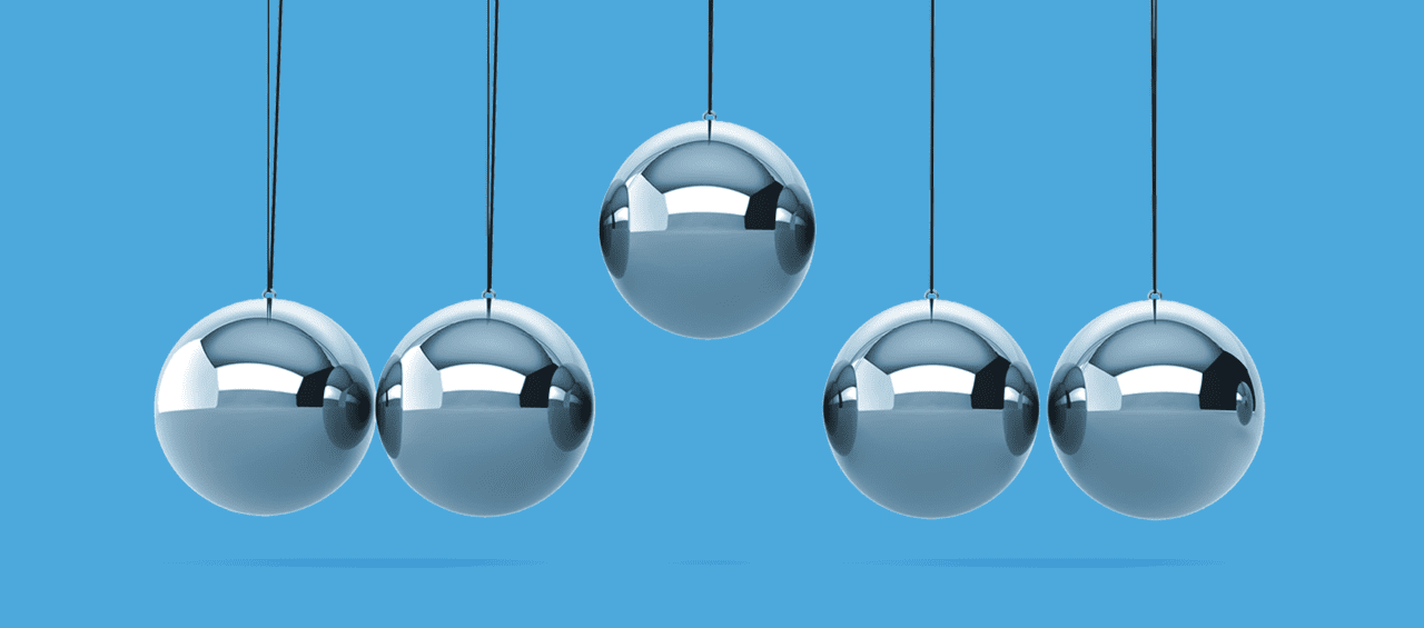 Newtons Cradle Balance Balls with the center ball lifted higher than the rest on a blue background